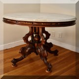 F15. Eastlake style marble top oval side table. 31”h x 32”w x 23”d - $220 